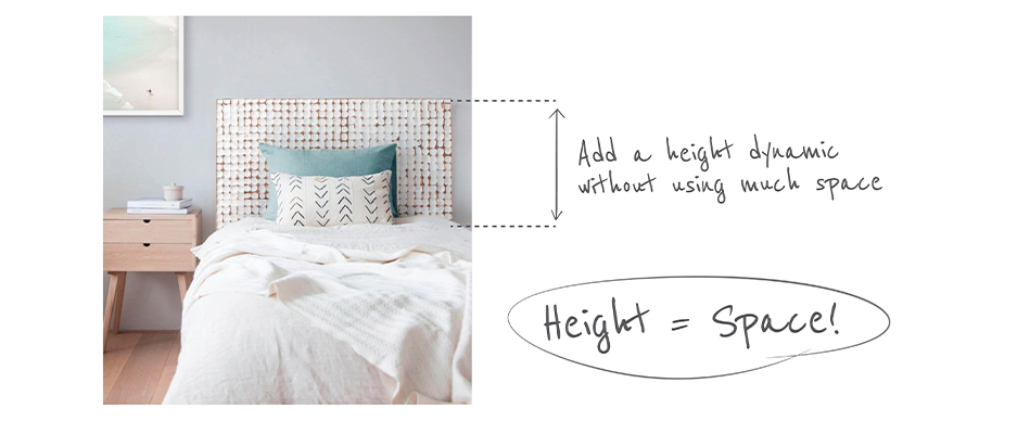 Light and airy bedroom with wooden white washed headboard